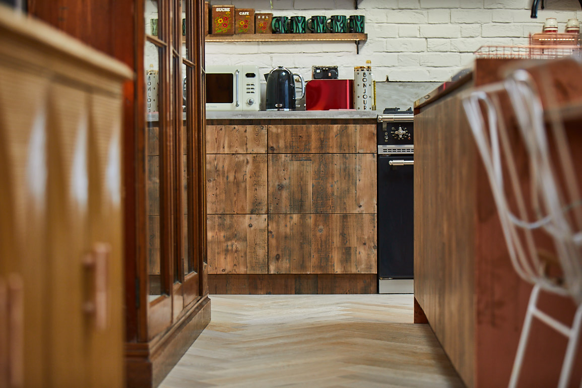 Reclaimed kitchen drawers sit next to black Lacanche Macon range cooker