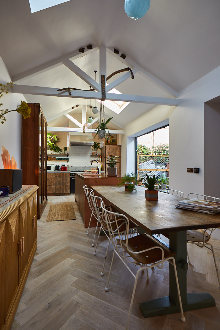 Open plan bespoke kitchen with parquet flooring