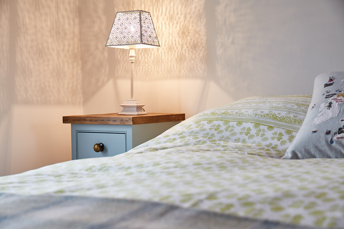 Blue painted bed side table with rustic pine worktop