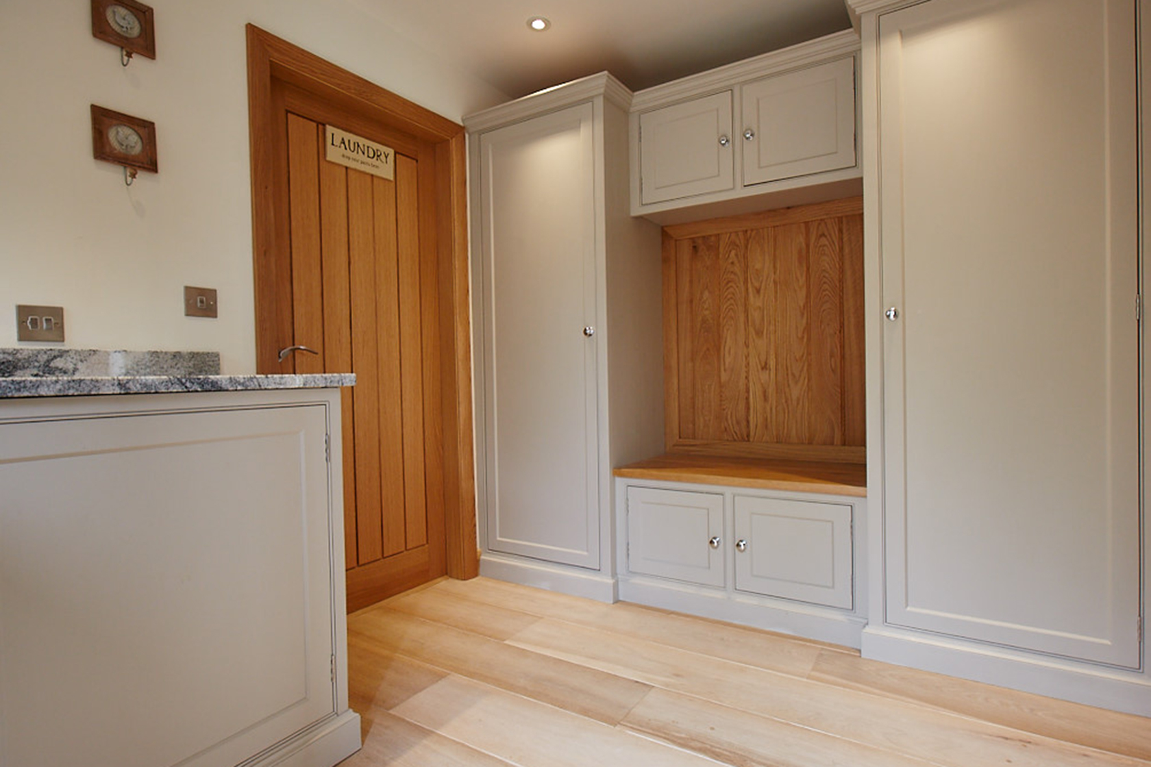 Laundry room with fitted units and seating area made from solid oak