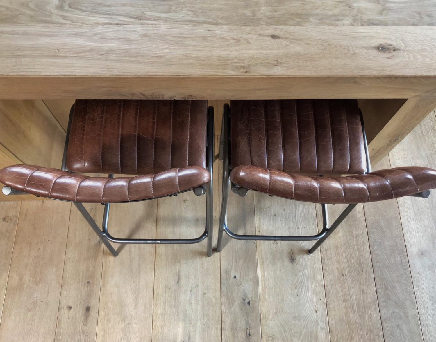 Clean french oak flooring with leather barstools