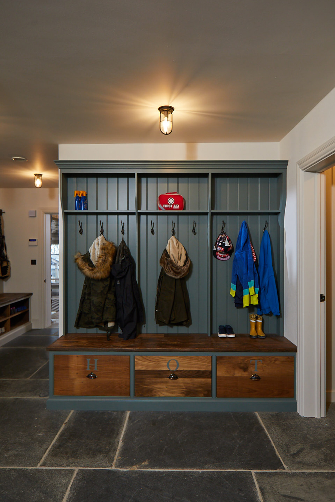 Dark green coat rack with dark oak drawers