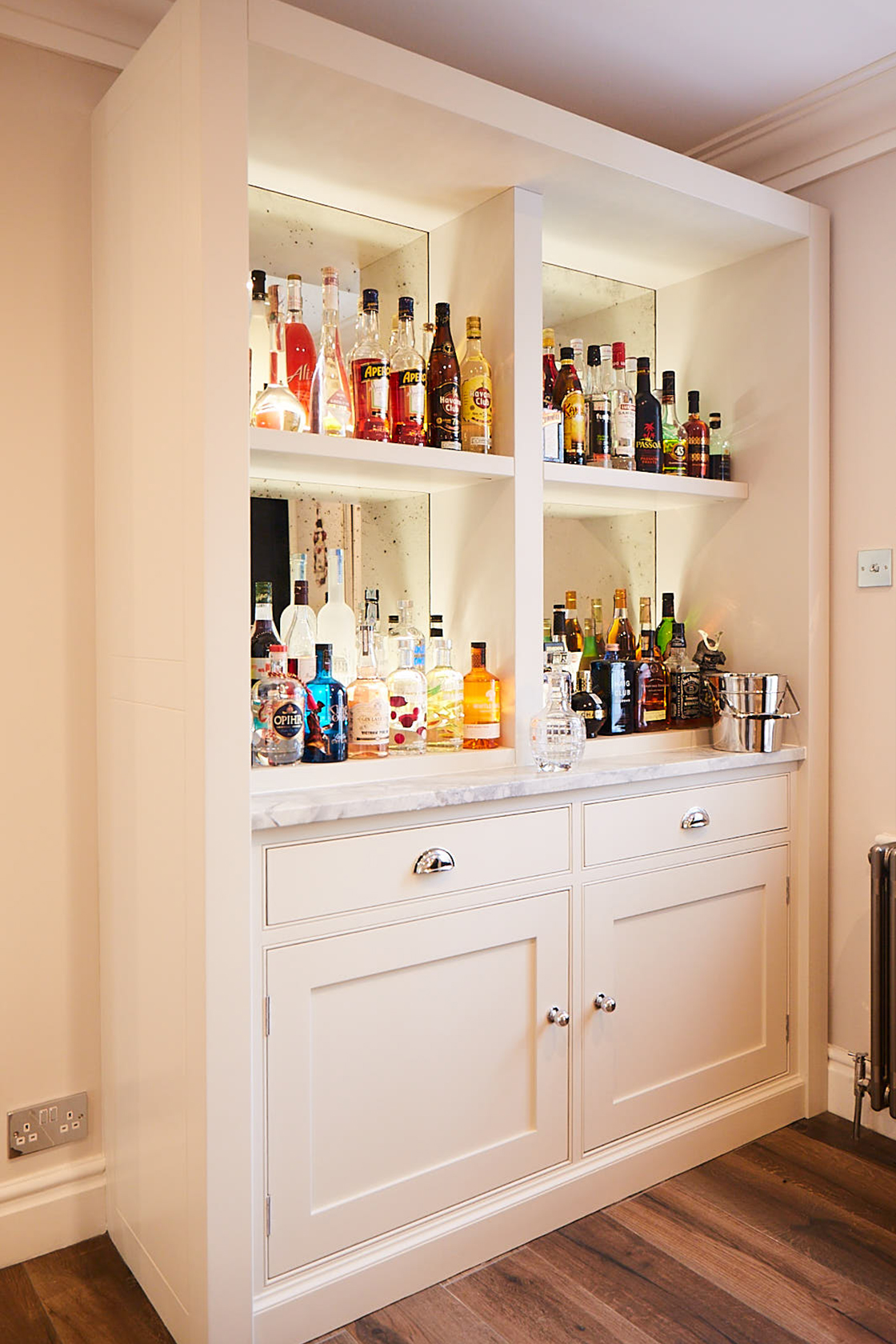 Drinks cabinet with rough old glass mirror painted in light grey