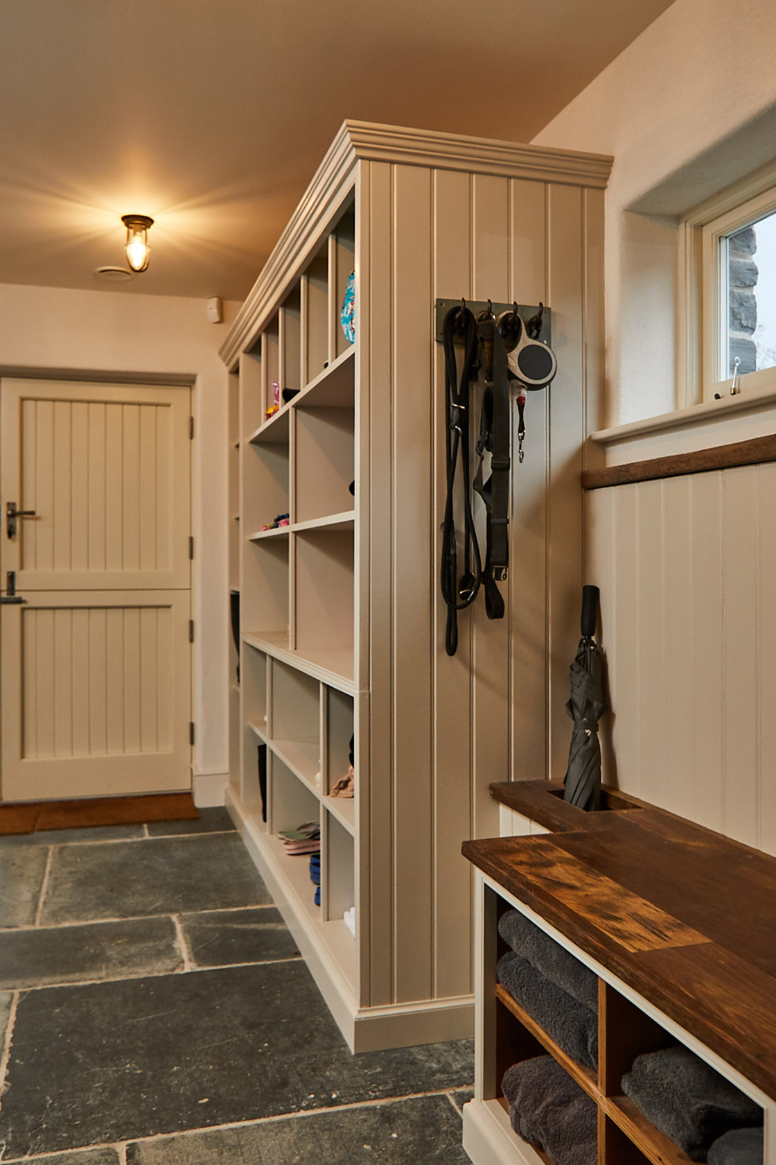 Light grey painted boot cupboard fully fitted in farmhouse