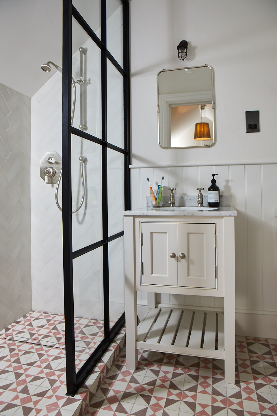 Painted vanity unit next to crittall shower screen