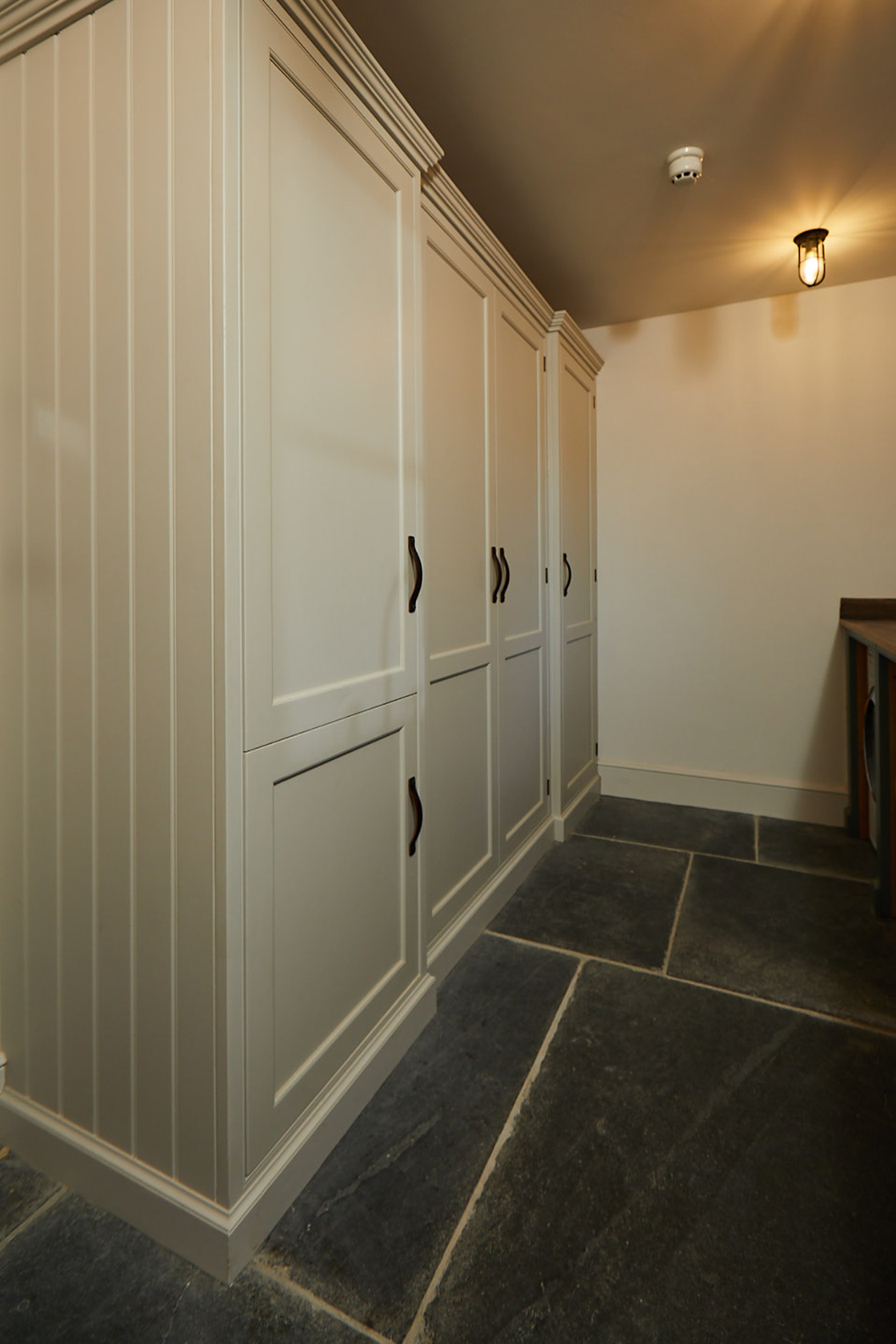 Tall integrated painted shaker cupboards with integrated washing machine and dryer