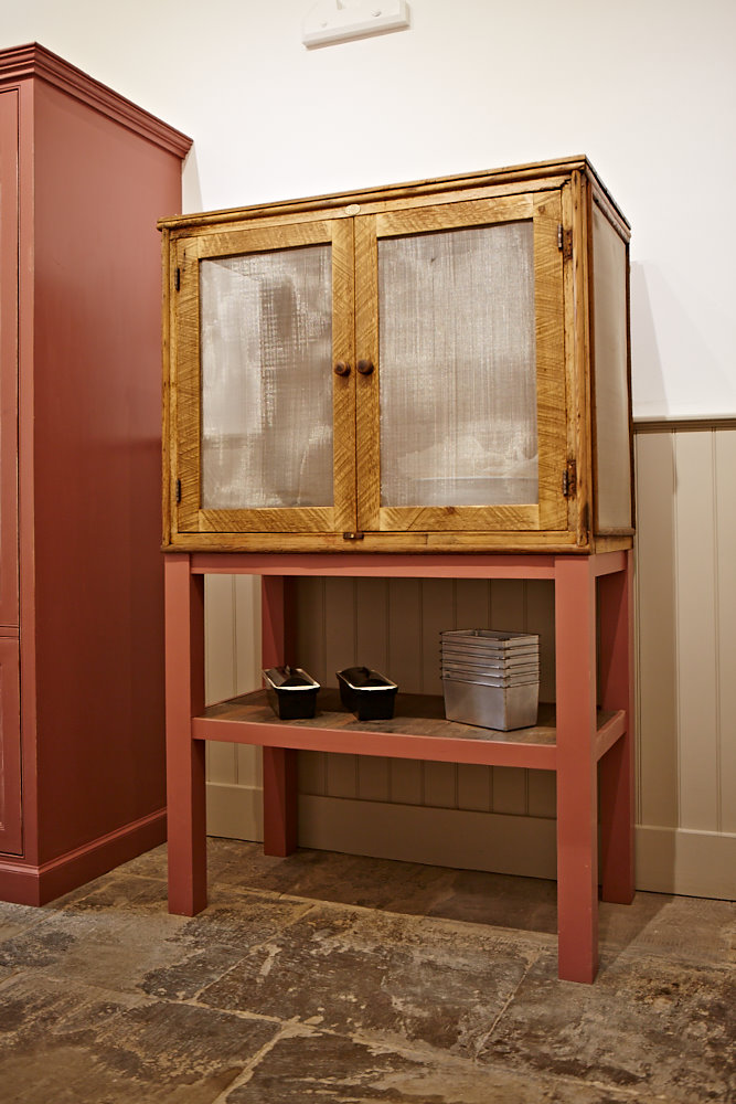 Restored double door cabinet with red painted legs