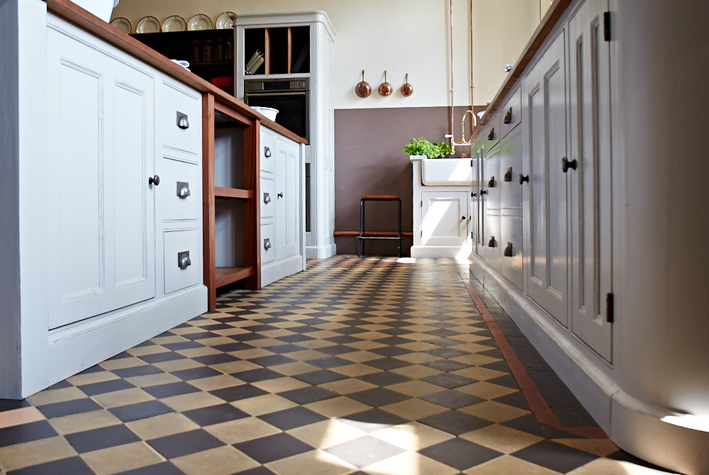 Original tiled floor with traditional painted kitchen cabinets
