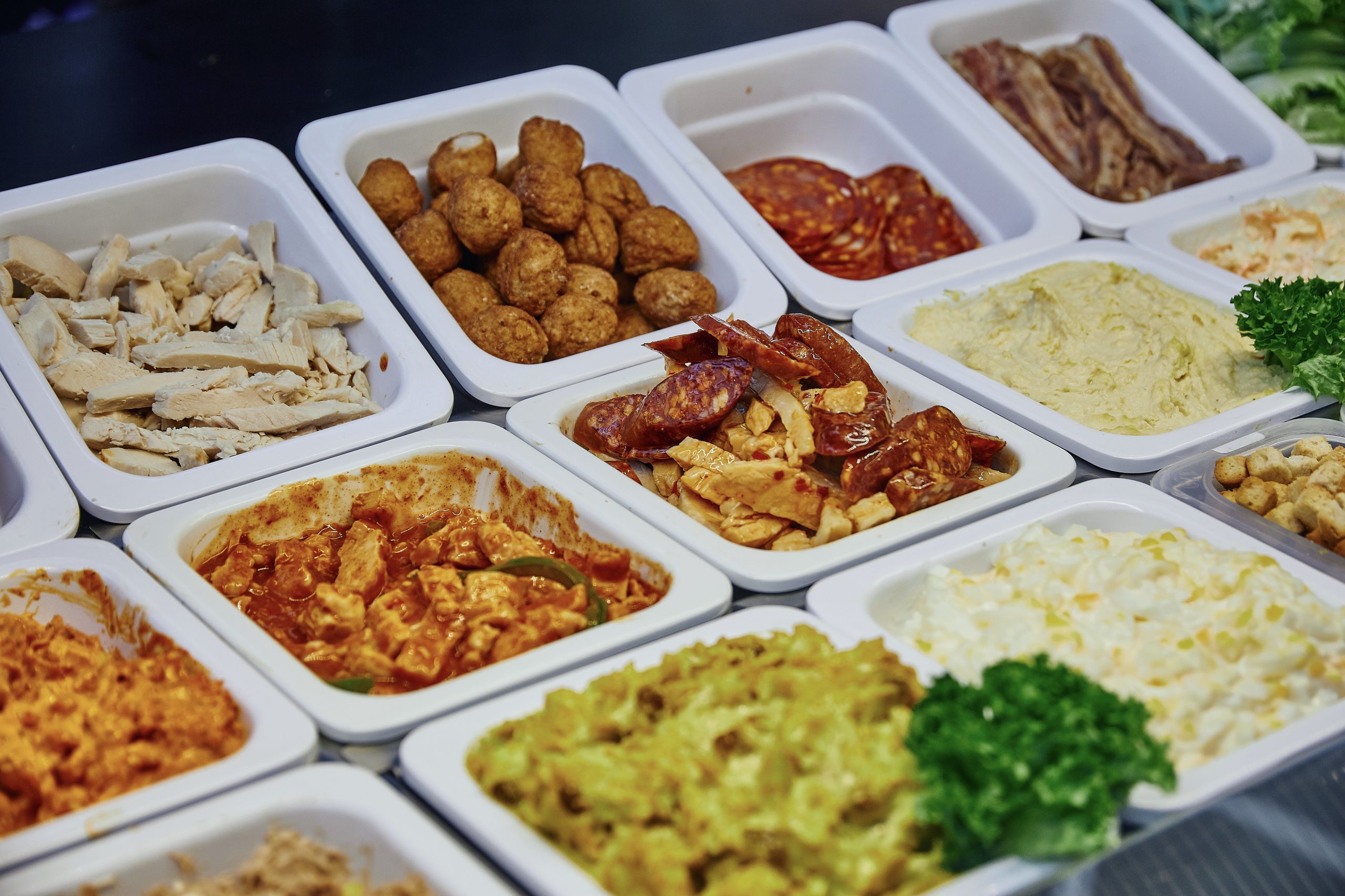 Deli meats on display in commercial food counter