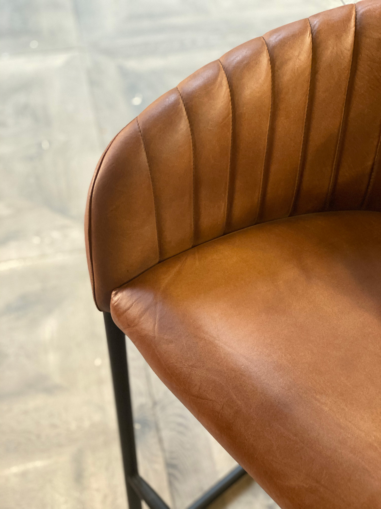 Shell pattern on brown leather bar stool