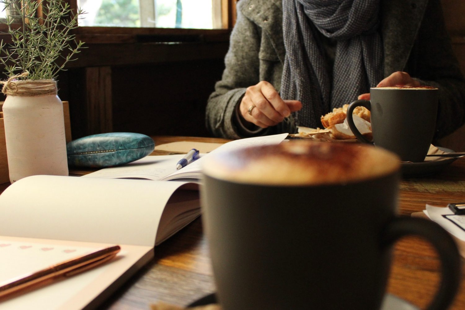 Fresh coffee and note book in a cafe