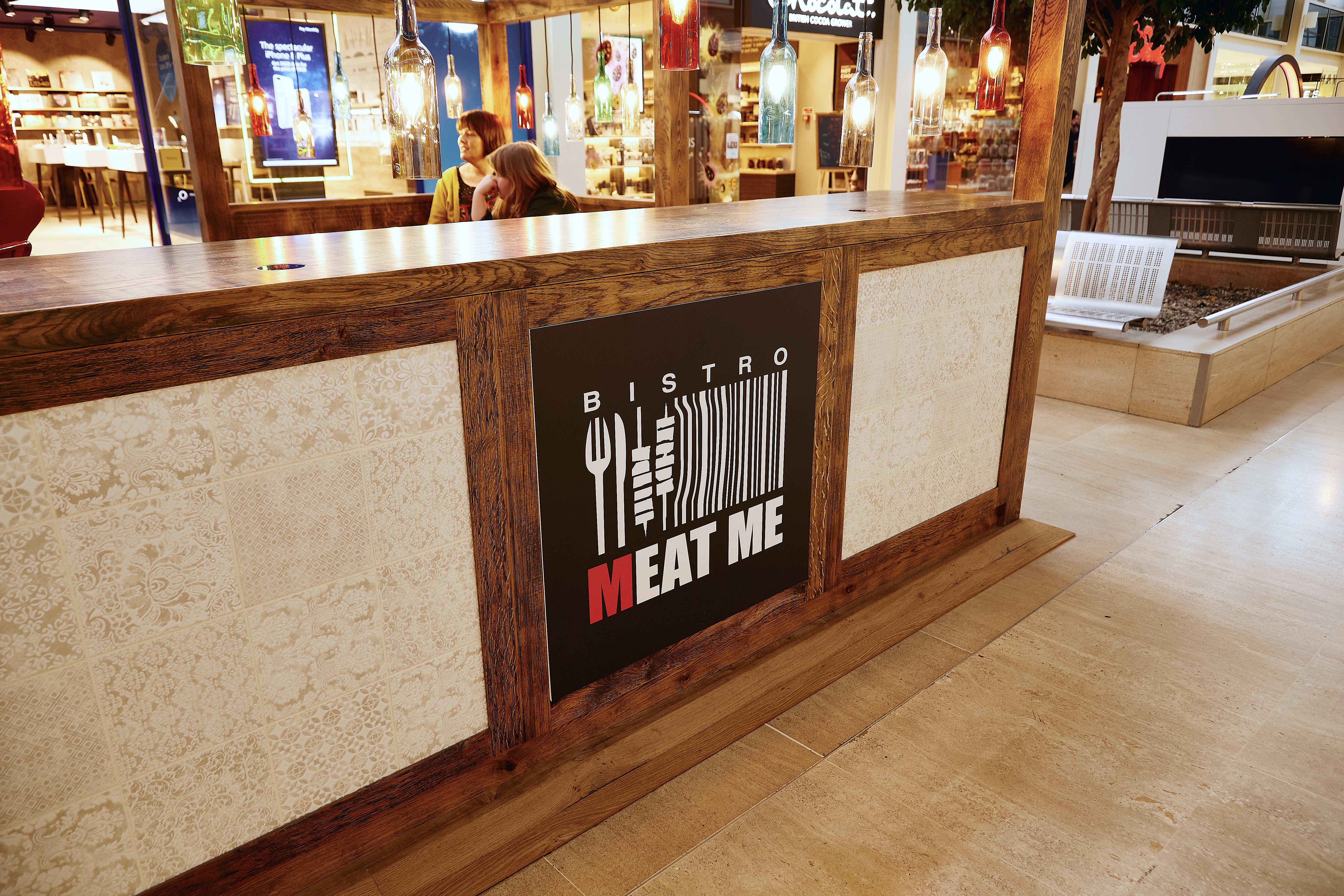 Branding board of Meat Me Bistro with tile and rustic wood surround
