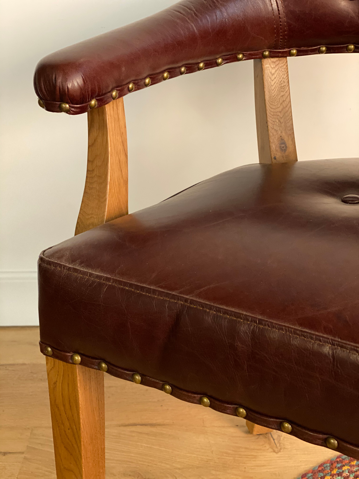 Leather office chair arm detail with brass studs