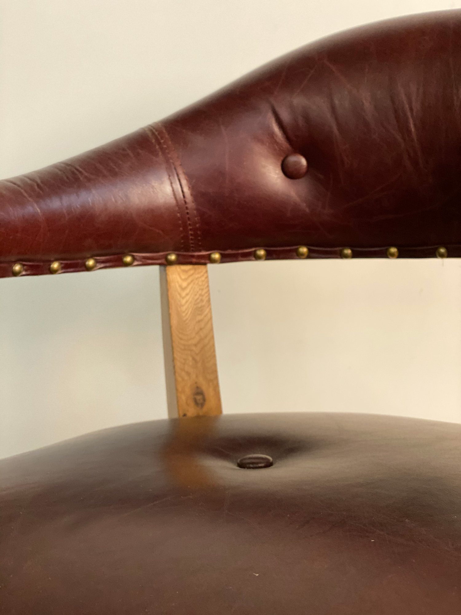 Office chair leather backrest with brass stud detail