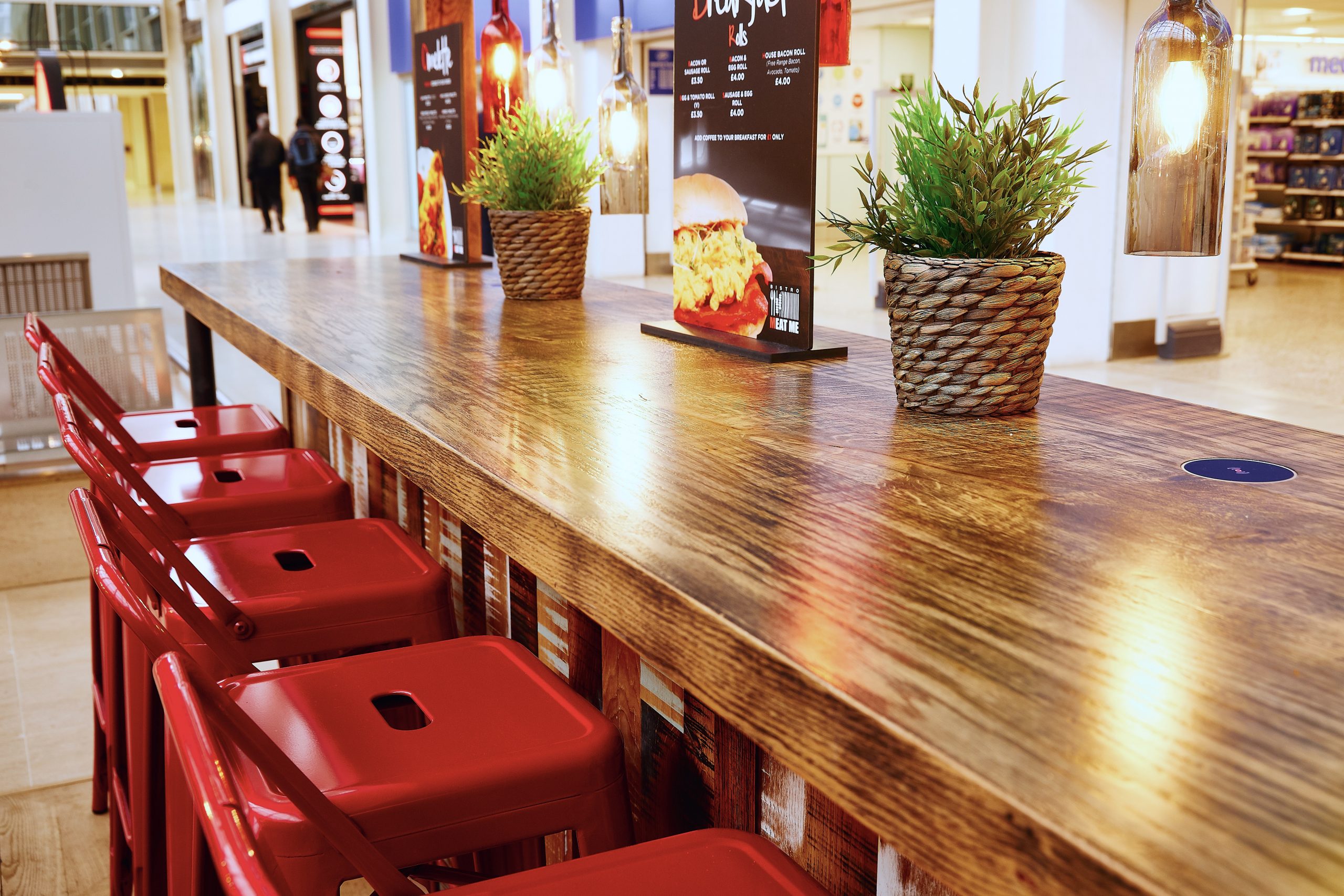 Rustic bar seating with red industrial stools