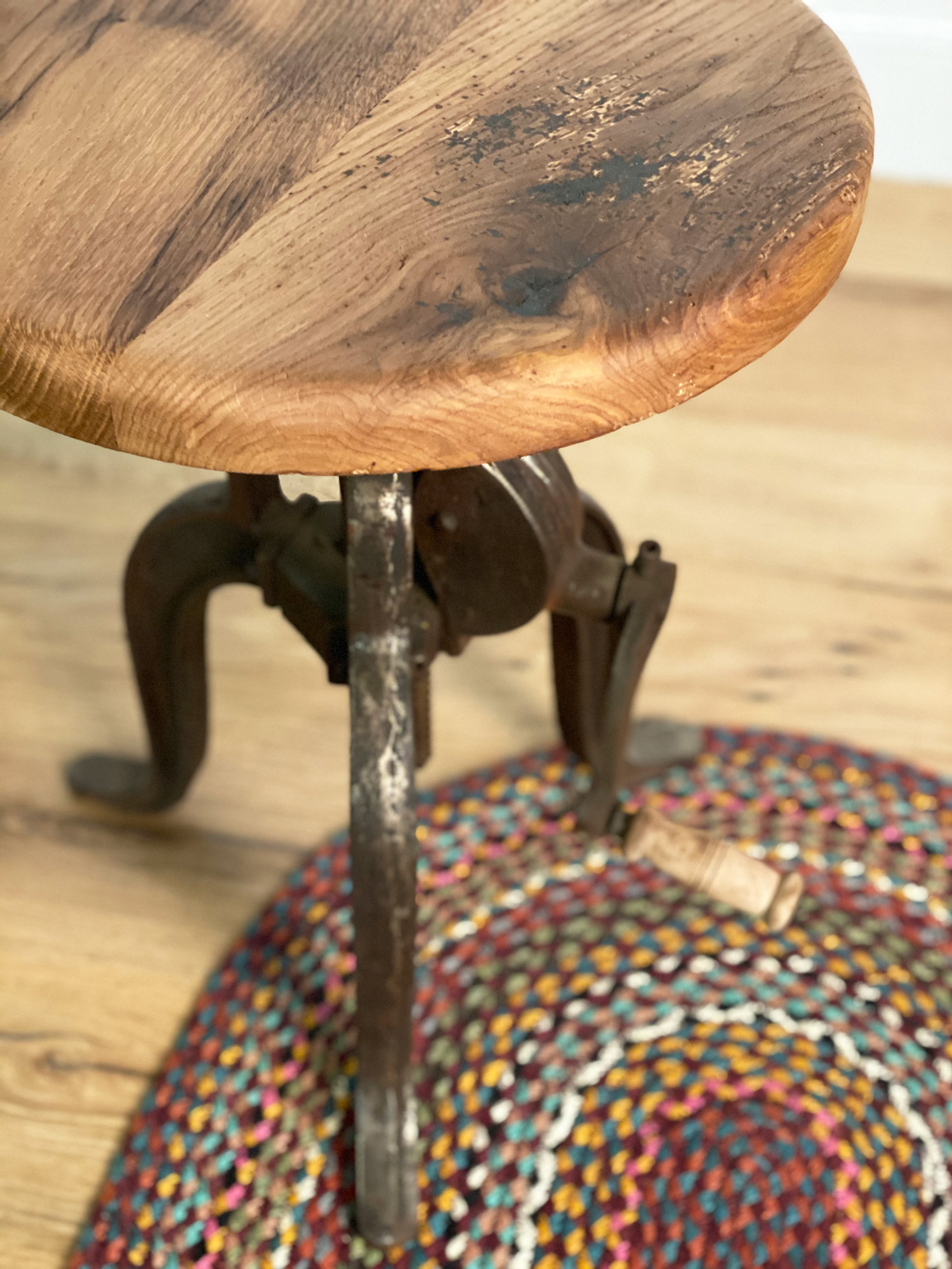 Oak side table with cast iron base or red rug