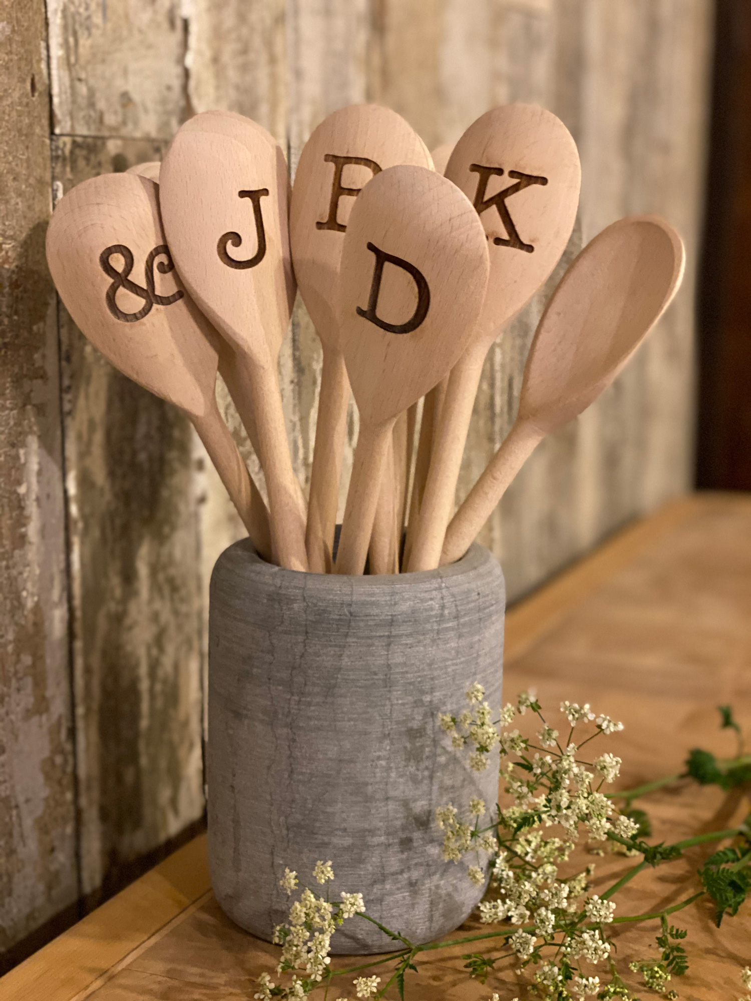 Wooden spoons with alphabet letters in concrete holder