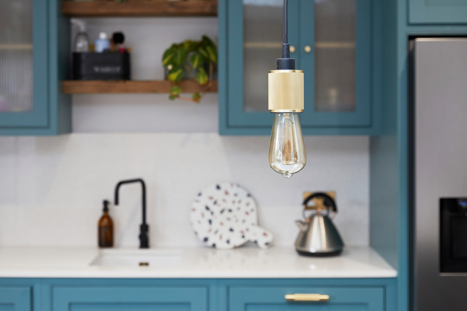 Buster and Punch heavy metal pendant light bulb above bespoke kitchen
