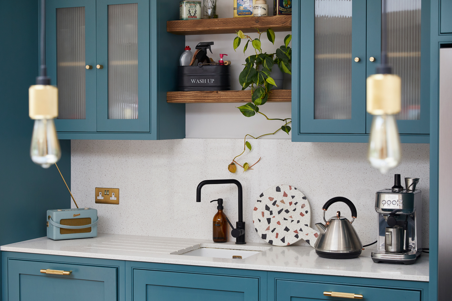 Reclaimed rustic pine scaffold board shelves sit above sink unit with quartz worktop