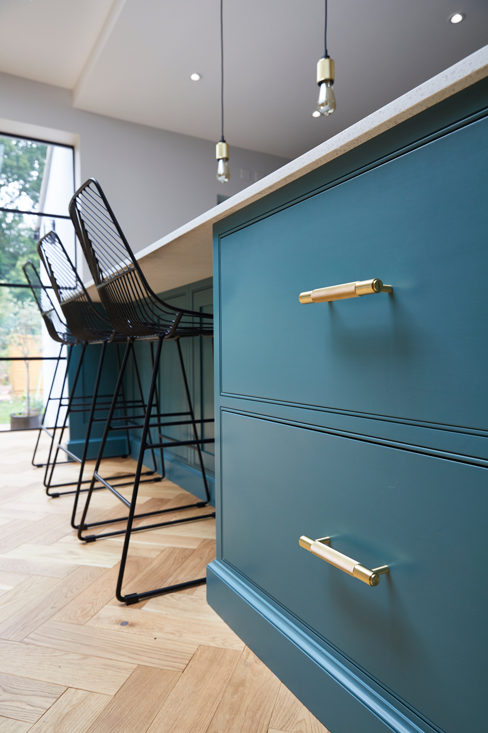 Pan drawers sit on oak parquet flooring with Buster and Punch brass bar pull handles