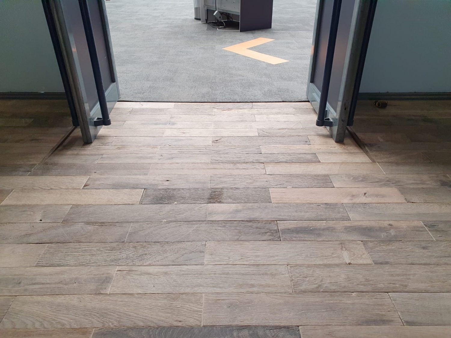 Reclaimed engineered flooring blocks laid on the showroom floor with integrated disabled ramp