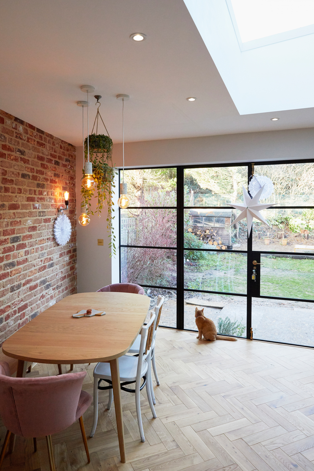 Oak modern kitchen table sits on oak parquet flooring