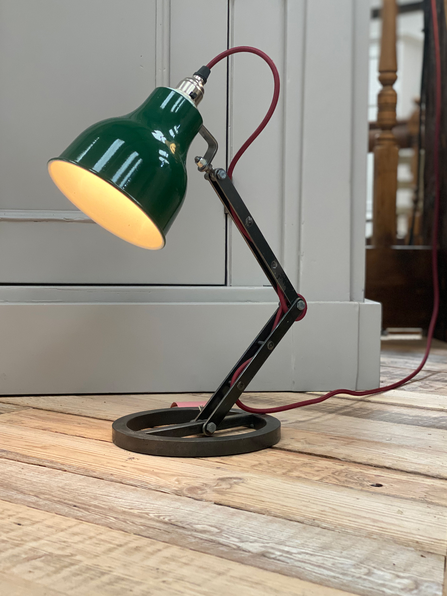 Industrial table lamp with green shade and red textile cord