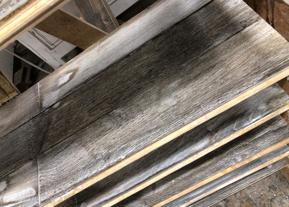 Whitewash reclaimed flooring in drying racks