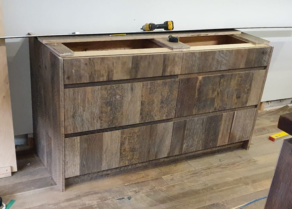 Reclaimed engineered pan drawers being installed in to London showroom