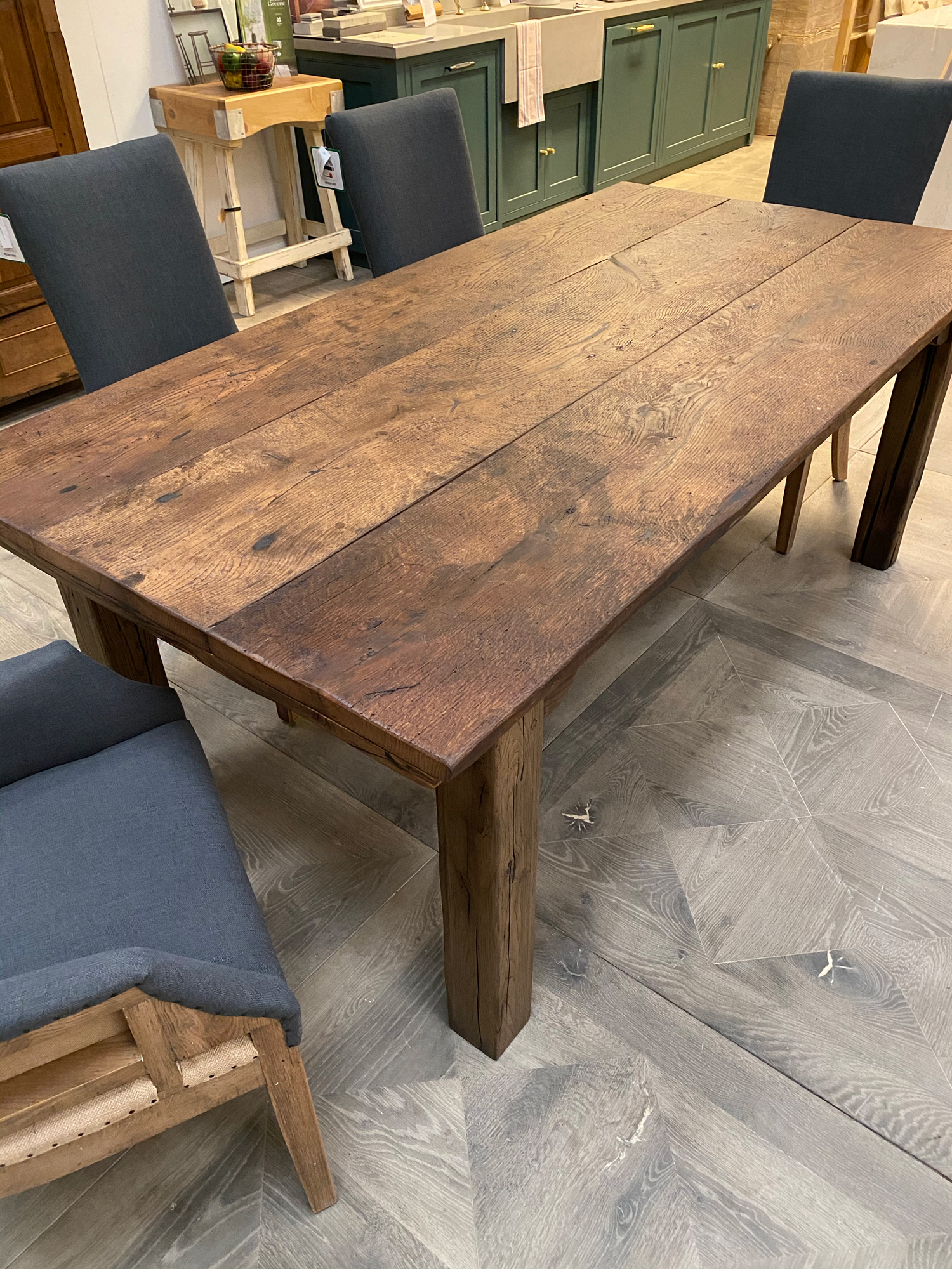 Reclaimed oak dining table with blue upholstered chairs