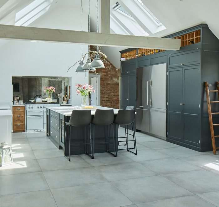 Bespoke kitchen with tall black cabinets and white range cooker