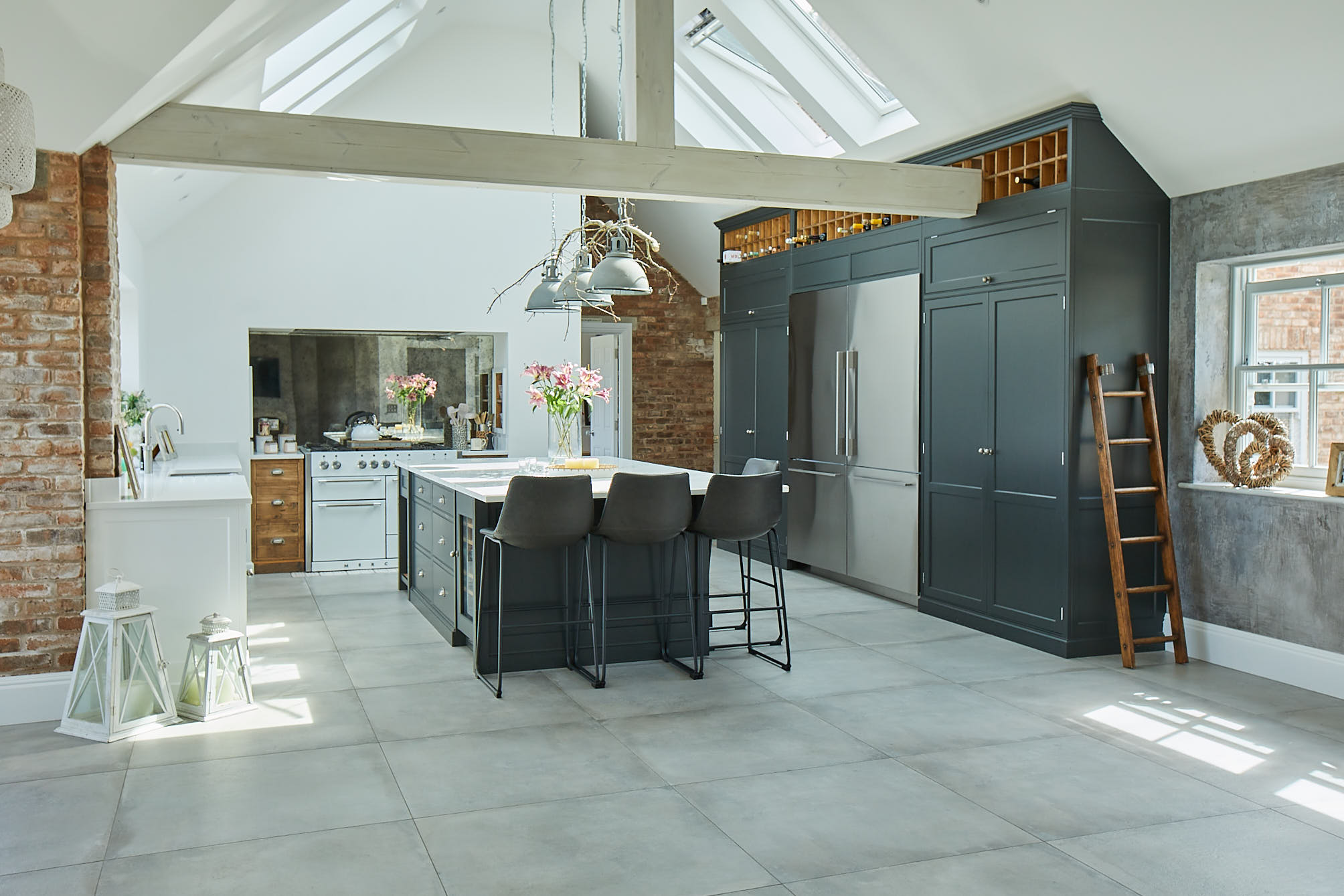 Bespoke kitchen with tall black cabinets and white range cooker