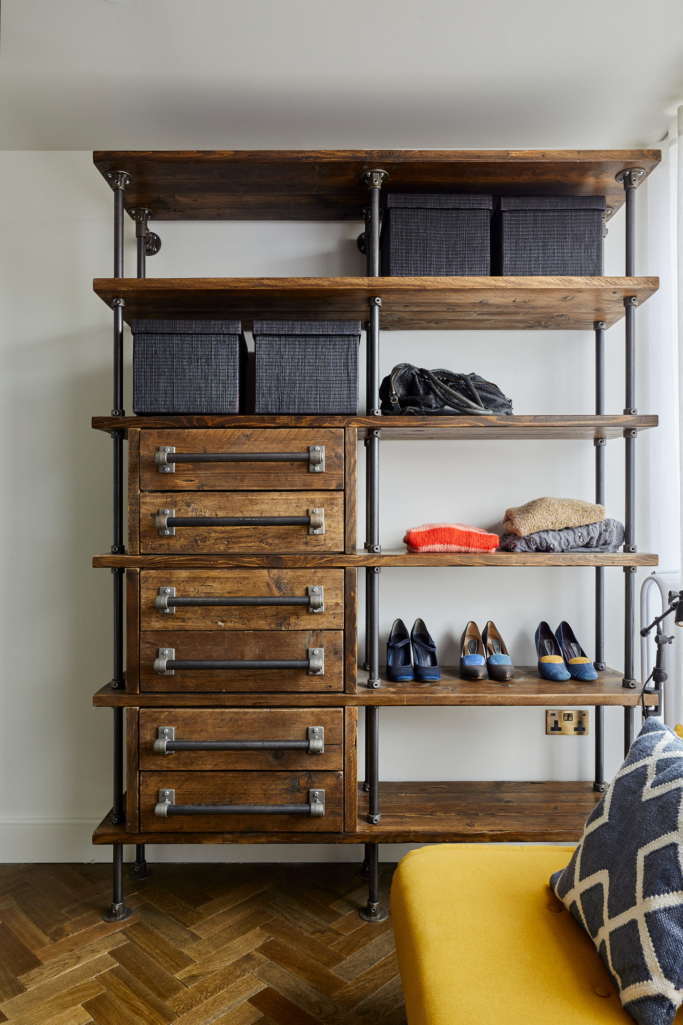 Reclaimed pine drawers with iron pipe hardware and parquet oak flooring