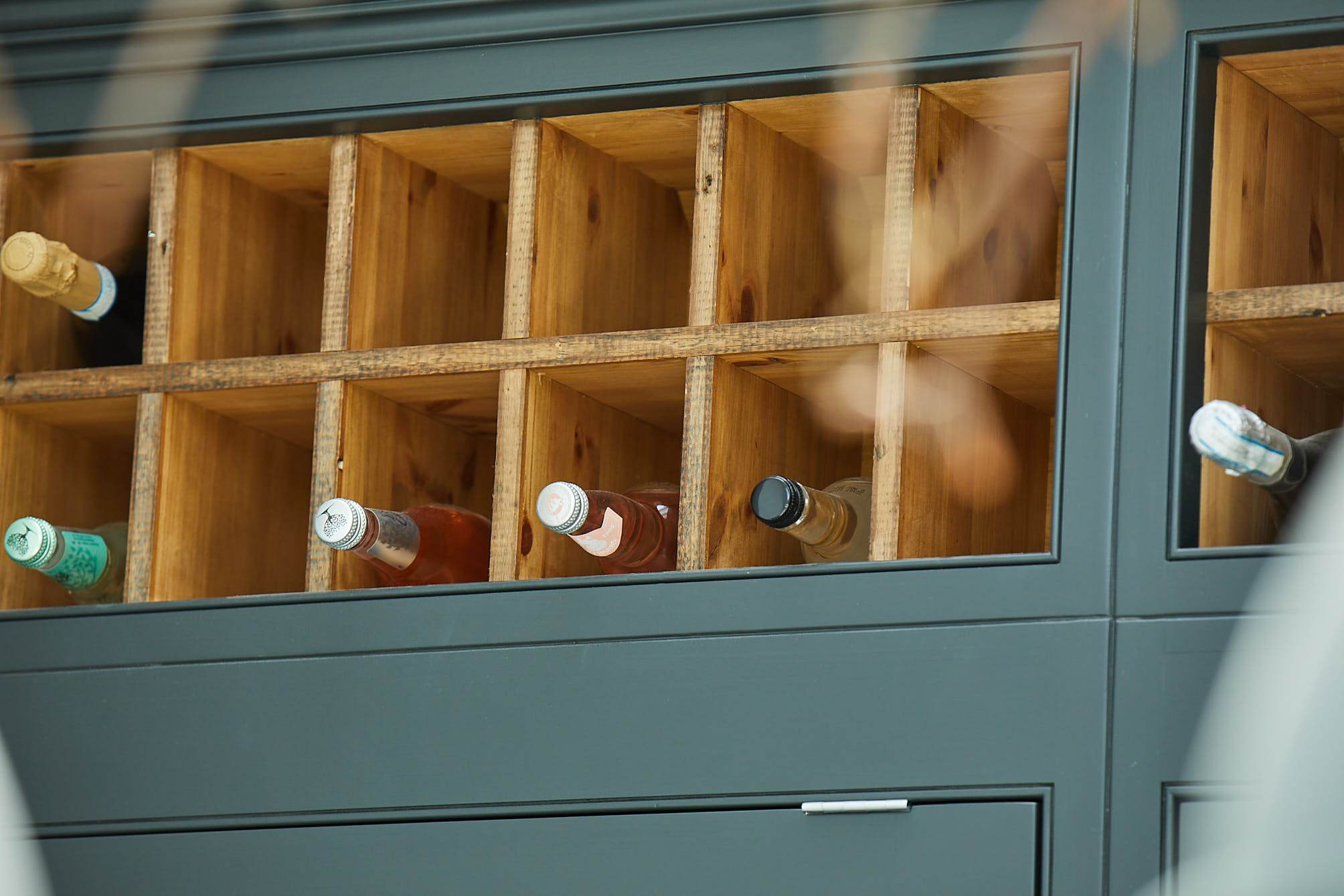 Rustic and painted wine rack filled with bottles