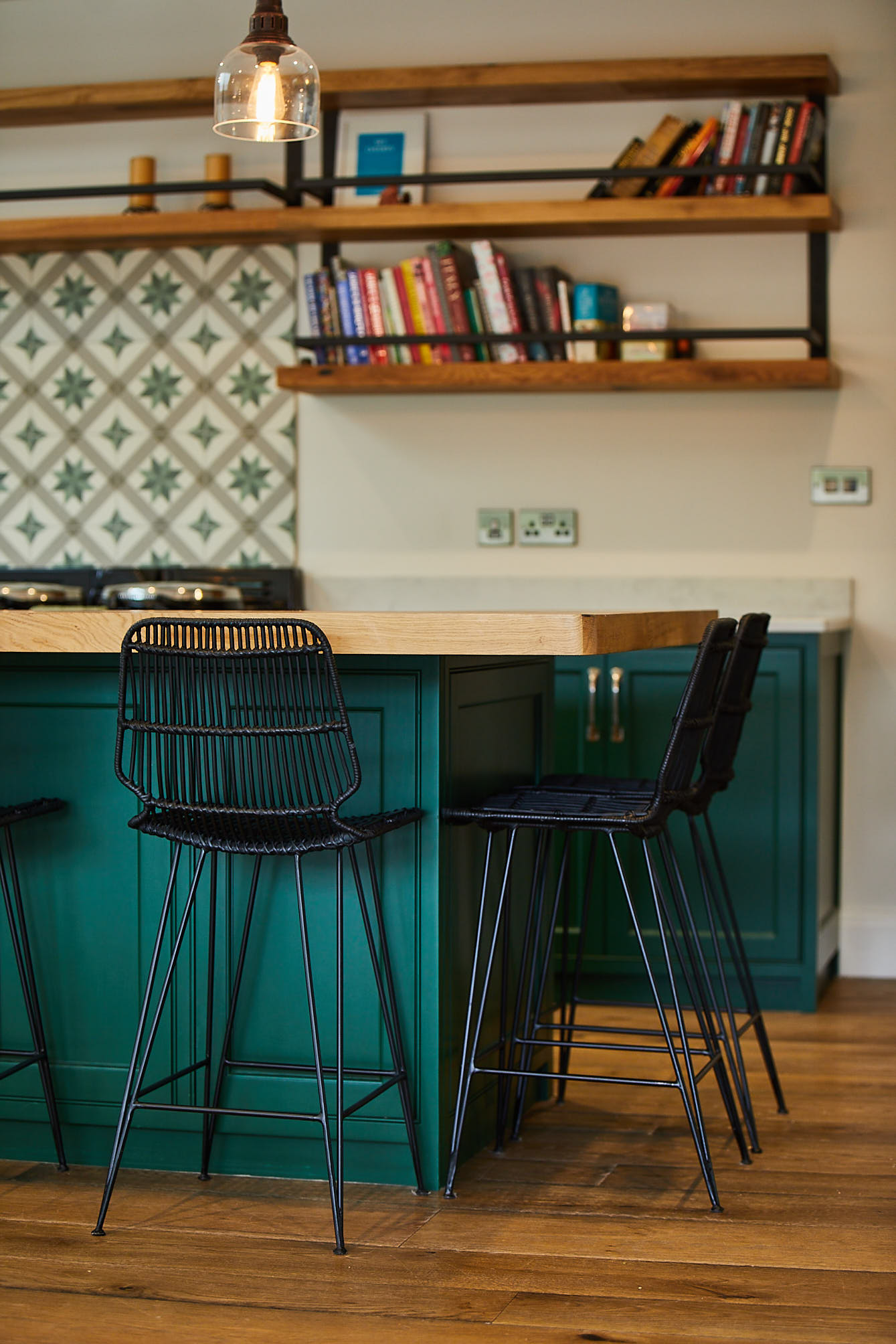 Black metal barstool with green bespoke kitchen island