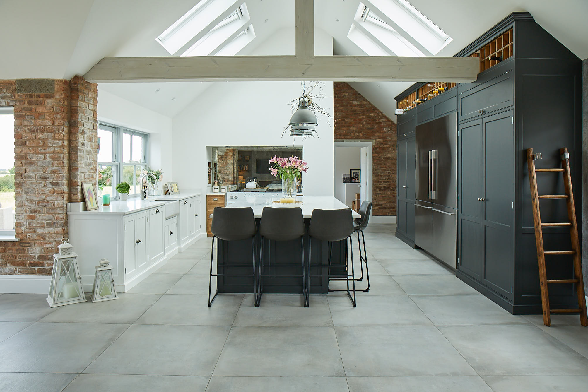 Lamp black kitchen units with leather barstools