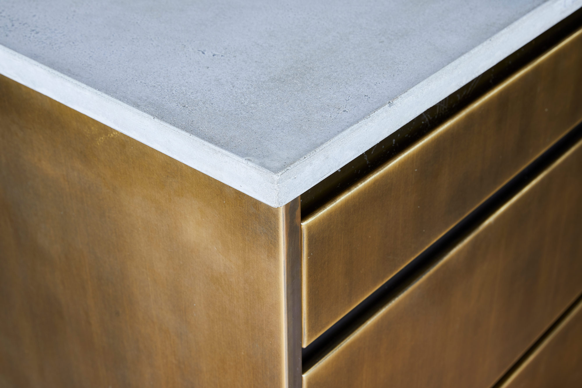 Solid concrete worktop on top of bespoke metal kitchen drawers