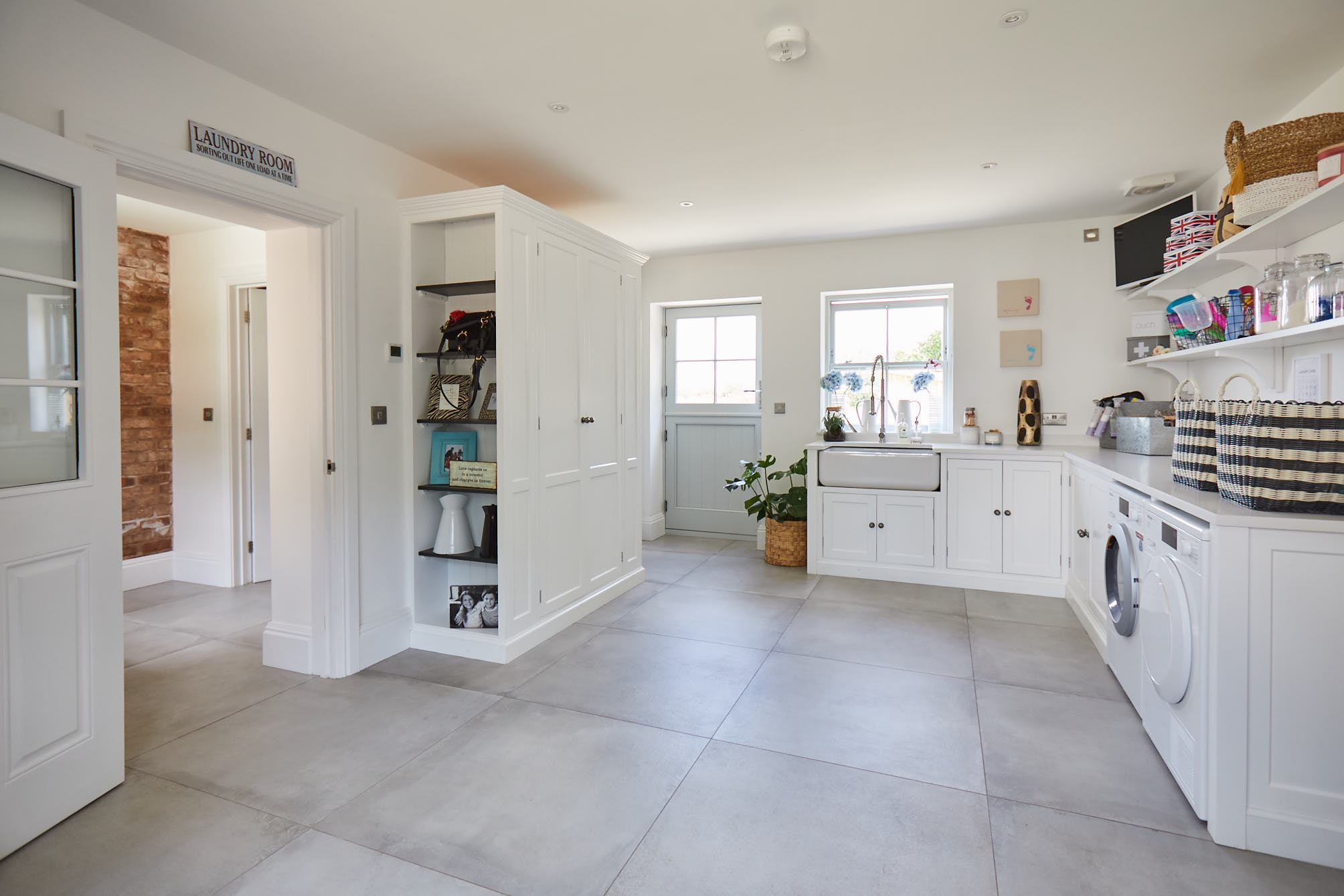 White utility room with open bookcase and Shaws double Belfast ceramic sink