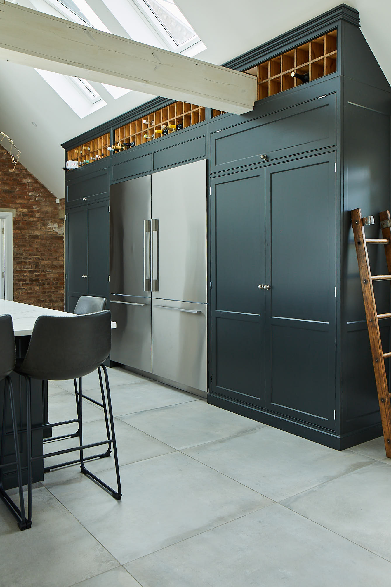 Large Lamp Black larder unit with integrated stainless steel fridge freezers in centre