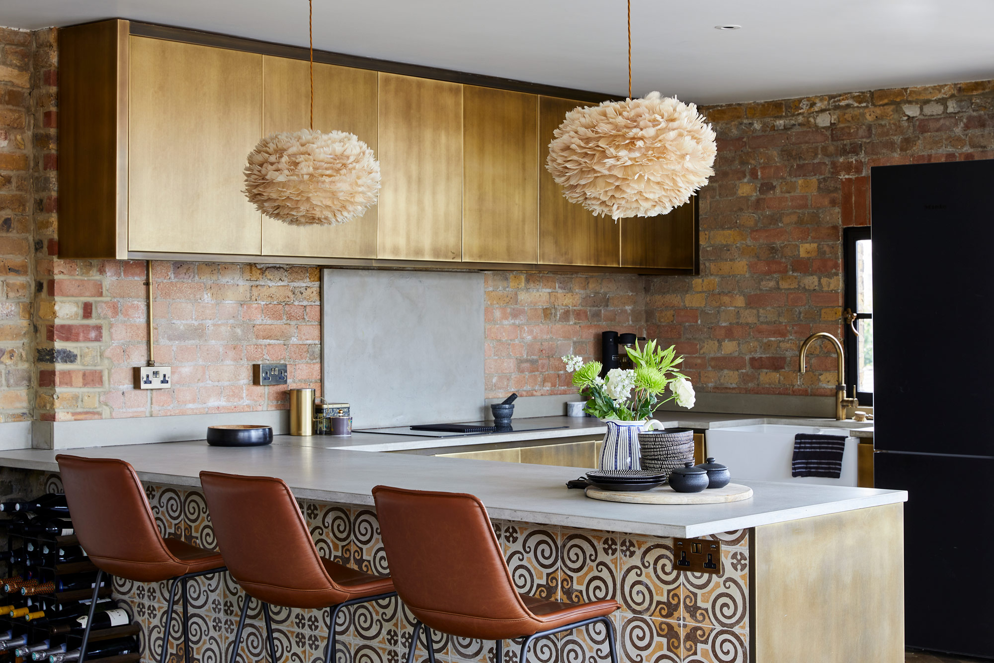 Brass metal kitchen with tiled peninsular