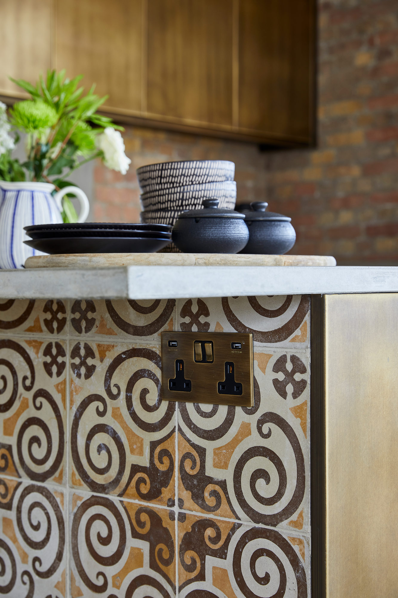 Bespoke kitchen integrated brass plug socket on reclaimed tiles