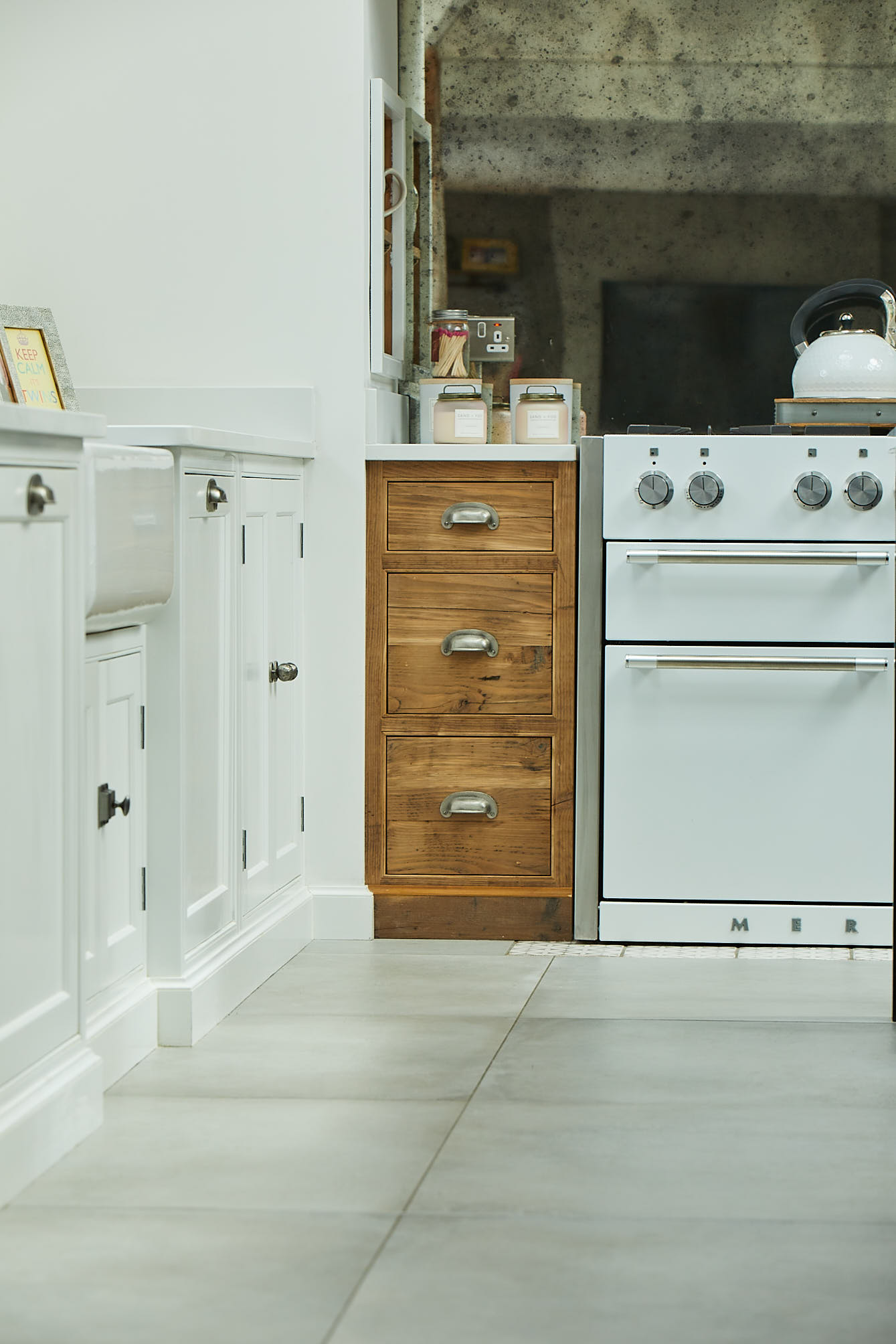 Reclaimed rustic pan drawers next to white Mercury range cooker