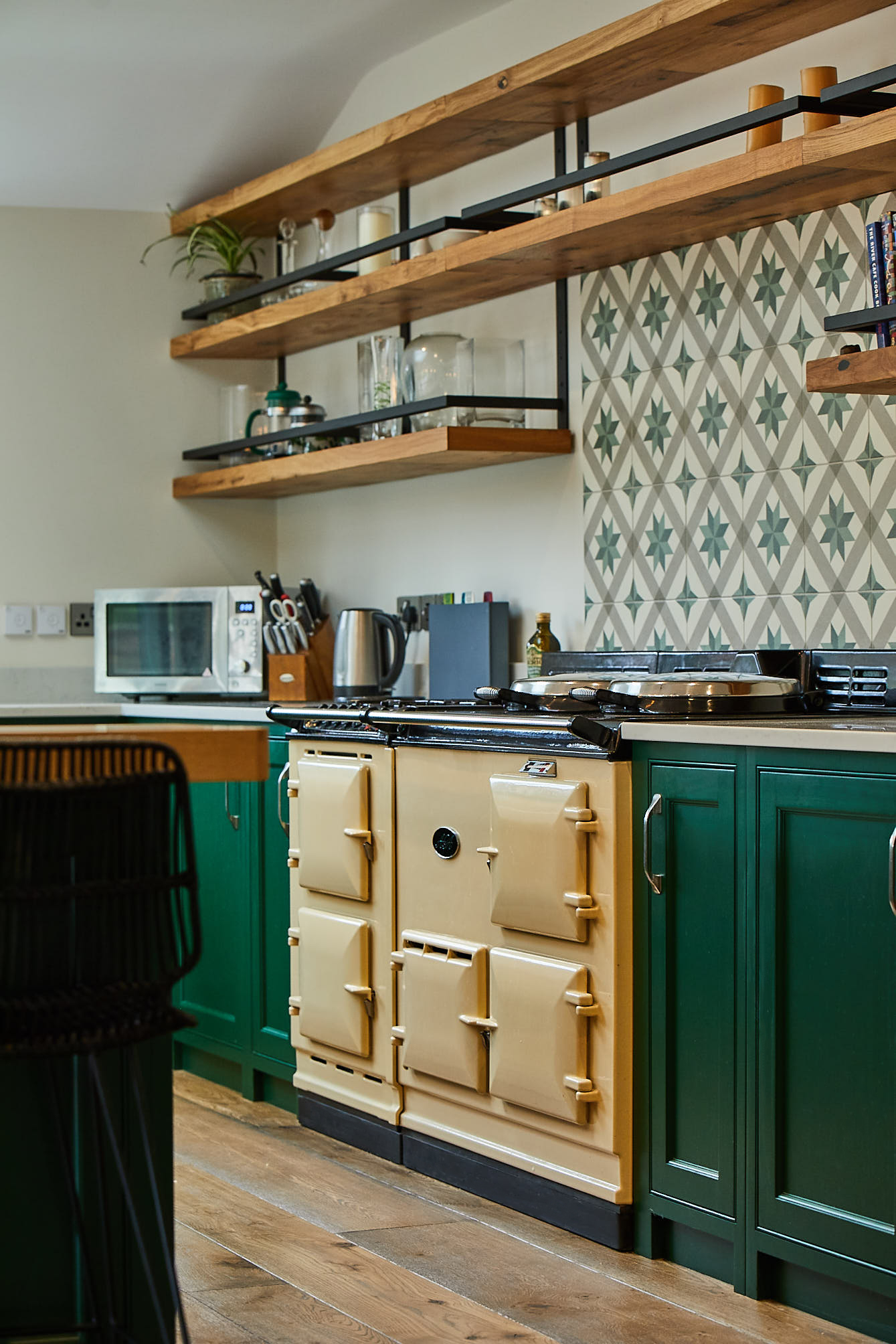Cream AGA in bespoke kitchen with green shaker cabinets painted in Little Greene paint