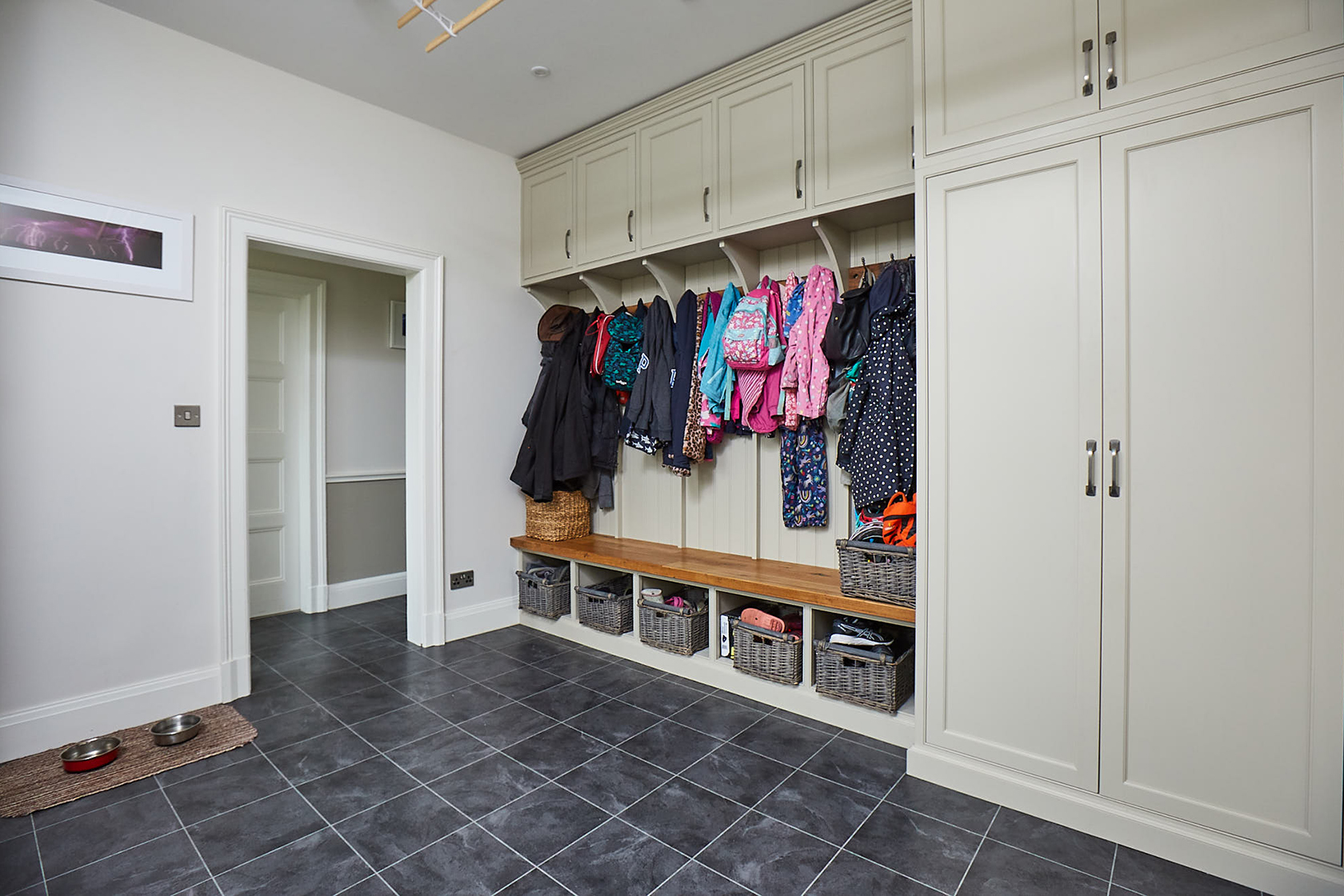 Fitted coat rack with storage lockers painted in Little Greene