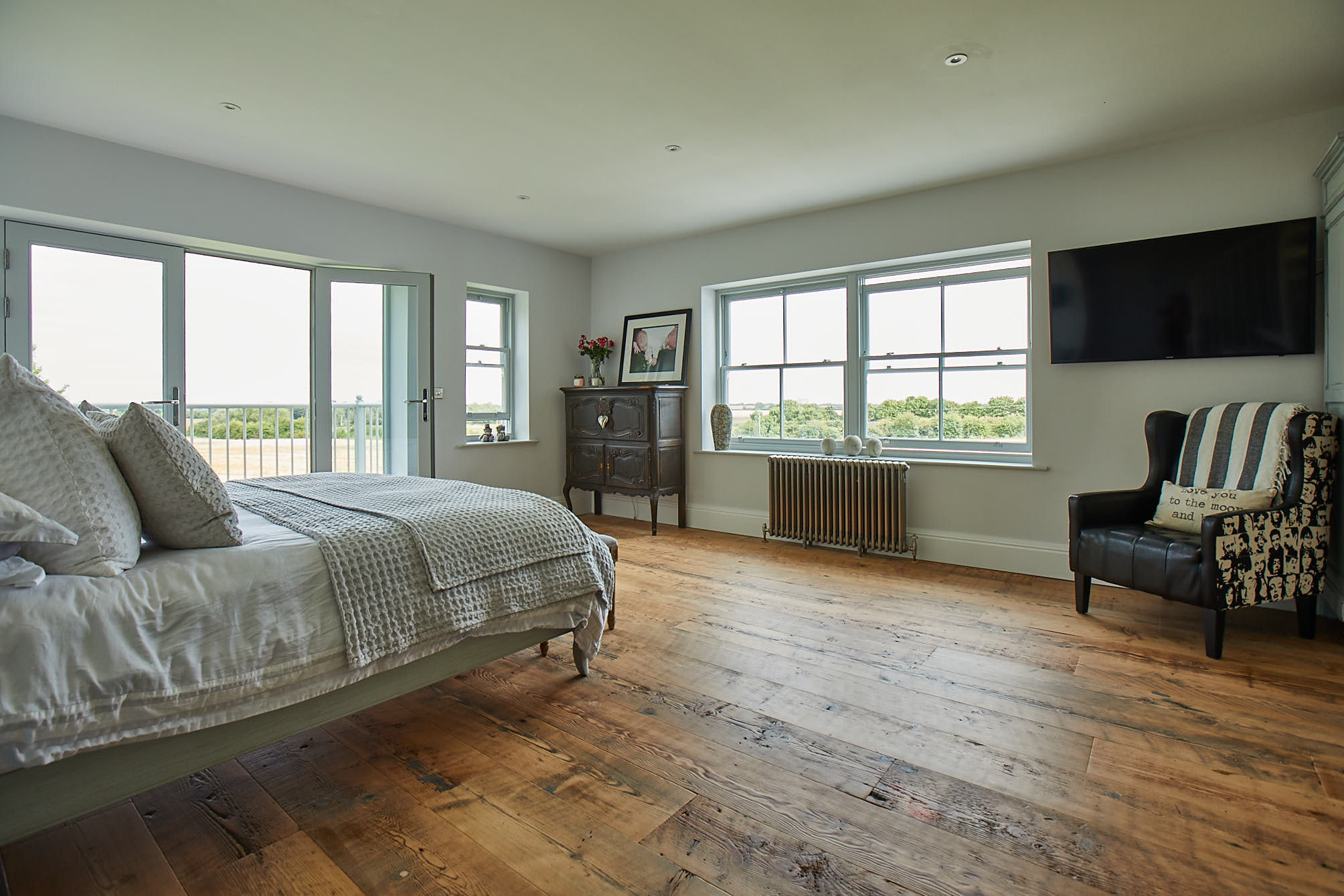 Rustic flooring in bedroom with original pieces of furniture