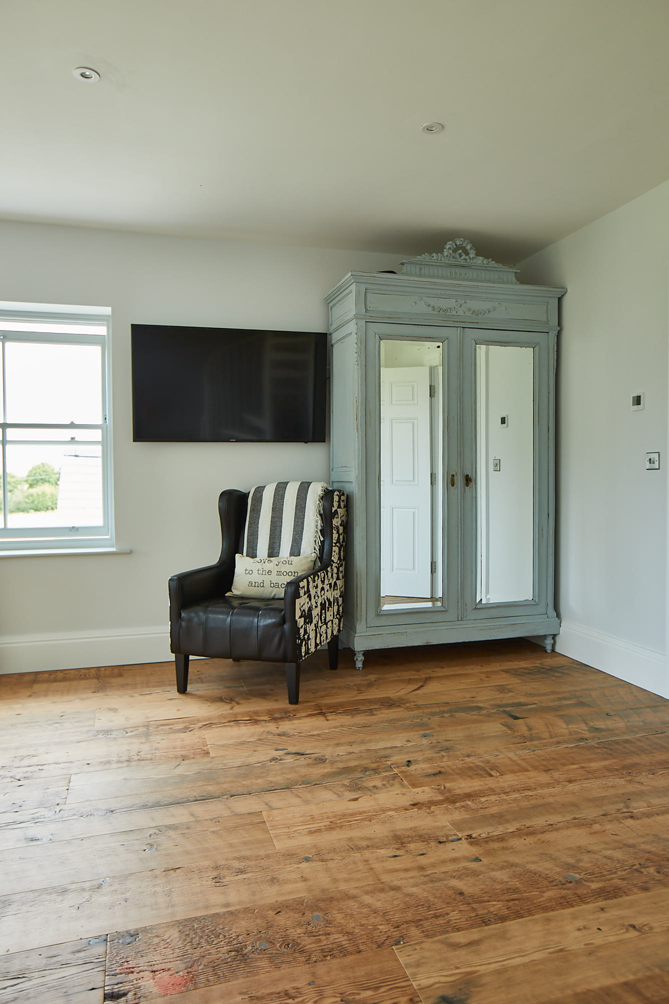 Original blue wardrobe sits on rustic flooring