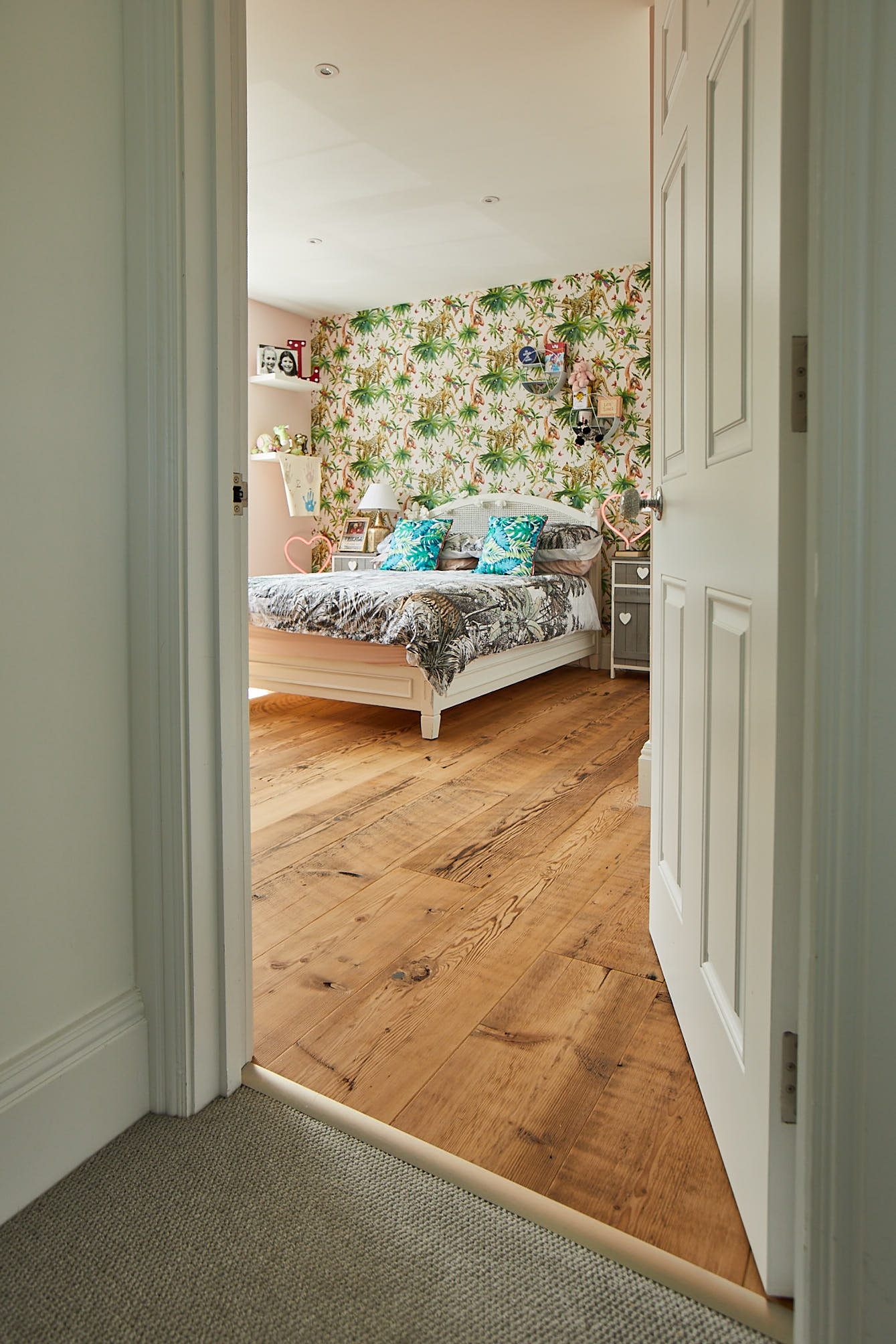 Door leading to bedroom with jungle wallpaper