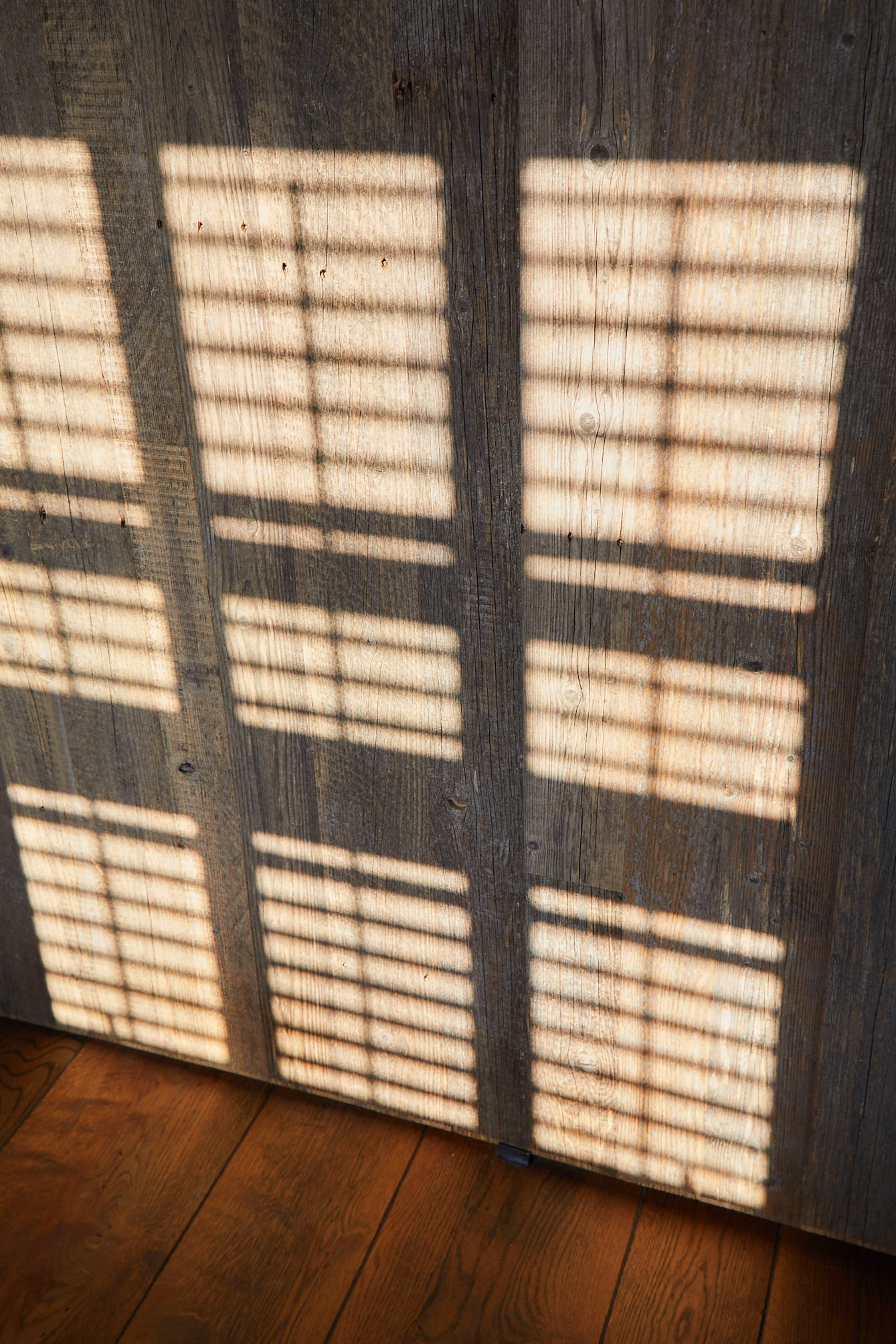 Sunlight hitting reclaimed wood cladding