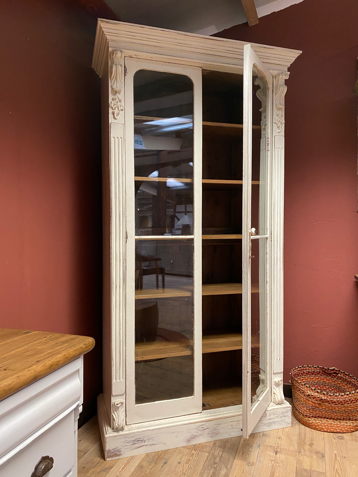 Single door open on tall glazed original bookcase