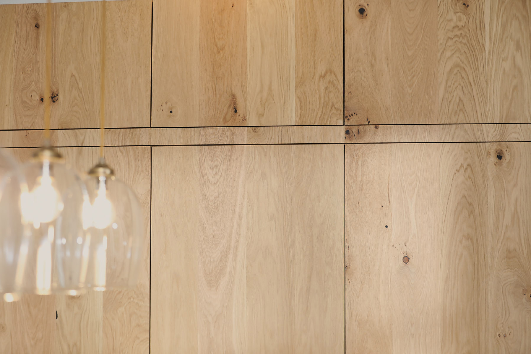 Tall oak cabinets with seamless grain running across doors